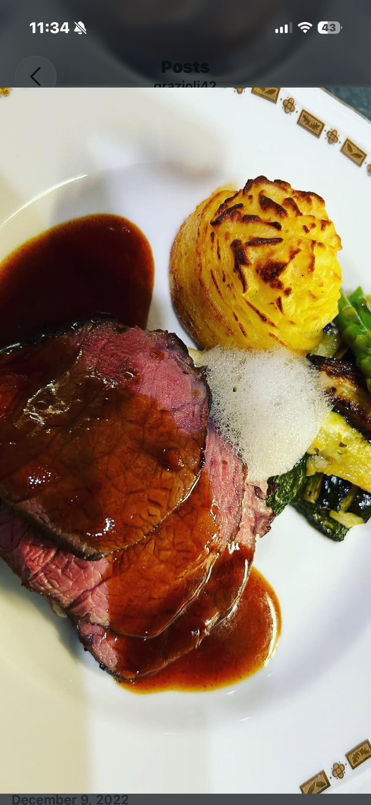 Sliced beef with golden potato dome and red wine jus